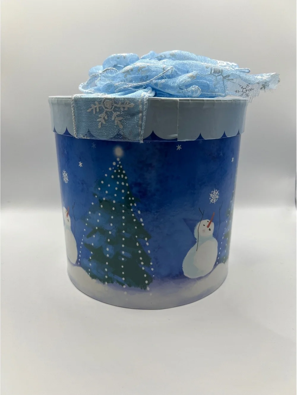 Blue Holiday Christmas cylinder round gift box with snowman and Christmas tree